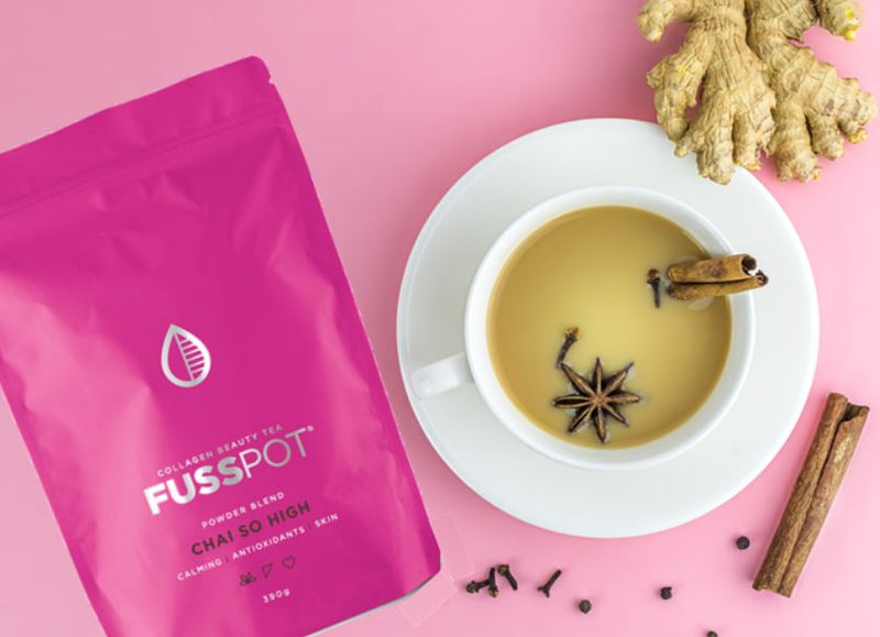 Chai with collagen. collagen chai. Fusspot Collagen Beauty Tea Celebrity Skin with hydrolyzed collagen peptides as a beauty tea to support skin, hair and nails, anti-ageing, reduce wrinkles.  Hot pink packaging. Beauty Product. Beauty Tea with collagen peptides,  chai Tea. cup of chai with cinnamon